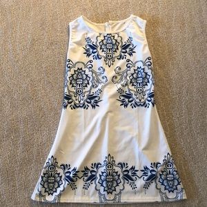 Sleeveless white dress with blue print